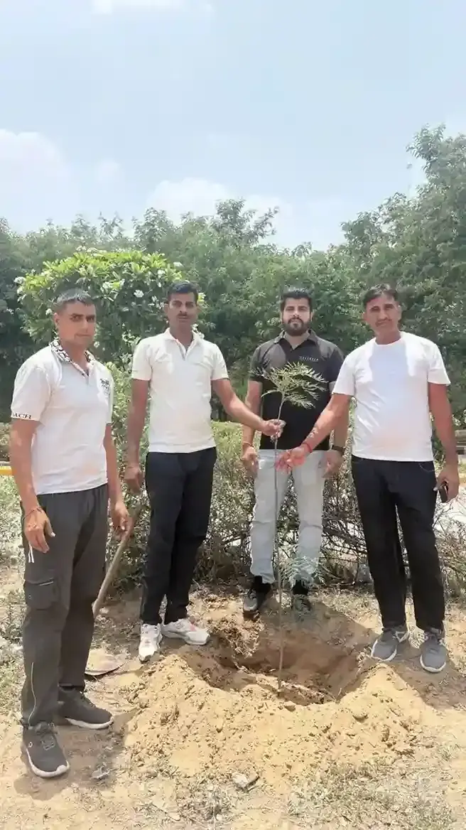 Volunteers and students planting trees and holding saplings